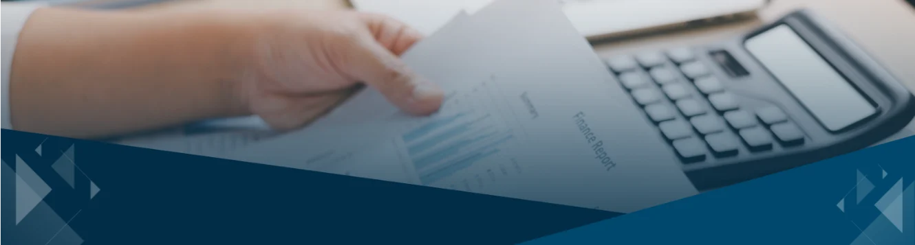 Business advisor reviewing financial reports and charts on desk